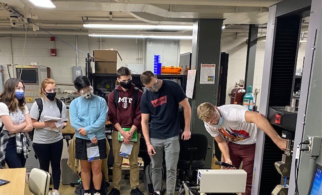 photo of ROTC cadets looking at CNC machinery