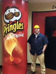 Tyler Corum standing beside large Pringles can